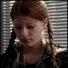 showing a person with braided hair and dark clothing against a striped background, with text fragments appearing sequentially