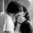 Black-and-white pixelated image of two people embracing, with overlaid text expressing fear about revealing a secret to one person.
