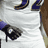 Pixelated football player in white jersey with blue number 52, black headband, and Reebok logo on purple