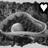 Black-and-white pixelated image showing two identical curved shapes with rounded ends, a white heart symbol above them, and text at the bottom.
