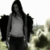 A 50x50 pixel animated contact sheet showing two frames of a grayscale image with a person in dark clothing and long hair standing outdoors on the left, transitioning to a close-up of their face on the right.