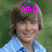 A pixelated image of a person with light brown hair wearing a light blue checkered shirt and dark blue tie, with pink text overlays on the left and right sides.