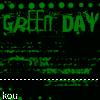 Green text displays 'GREEN DAY' repeatedly on a black background with pixelated green dots and scattered text fragments including 'american', 'kou', and 'idiot'.