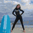 A person in a black wetsuit stands on a beach with a blue surfboard, transitioning to a person in a white hoodie and then a person in a pink sleeveless top.