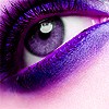 Close-up of a human eye with purple eyeshadow, long eyelashes, and a white sclera, set against a pinkish background.