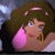 A pixelated contact sheet showing two frames of an animated icon featuring a cartoon woman with brown hair and blue eyes on the left, next to green text reading "Original Icons .com" on a dark background.