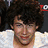 Four distinct facial expressions of a person with dark curly hair in a , each showing different mouth positions and eye states