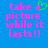 Blue background with pink pixelated text reading 'take a picture while it lasts!!' and a green pixelated heart symbol replacing the 'a' in 'a' on the left side.