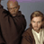 Static 49x49 pixel buddy icon showing two male characters in brown and beige clothing against a gray background with purple top edge.