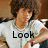 A person with curly brown hair wearing a white shirt appears in four with text overlays reading Look at the HOTNESS!!