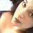Pixelated close-up of two figures in intimate pose with visible skin tones and dark hair against light background.