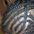 Pixelated static image with abstract light and dark blue, gray, brown tones forming indistinct shapes against a muted background.