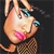 Pixelated cartoon character with light brown fur, blue eyeshadow, pink lips, and a checkered outfit against a dark background.