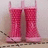 Two pink rubber boots with white tops sit on a wooden surface against a light wall, surrounded by pixelated text about rainy days and puddles.