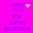 A bright pink background displays blue text reading "Lexy <3's the Jonas Brothers" with animated white pixel effects changing from a heart to starburst patterns.