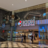 Pixelated static image showing a blurred interior with indistinct shapes and muted colors including brown, blue, and red tones.