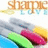 Pixelated image showing a dolphin leaping over colorful surfboards with 'Shoppie' text above.