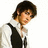 A person with dark curly hair wears a white shirt and black vest, shown in three sequential poses against a plain background.