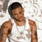 Pixelated image of a person with short dark hair wearing a white sleeveless shirt, arms raised in fists against a light background.
