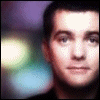 A person with short dark hair appears in three showing facial expression changes against a blurred background of purple, green, and yellow lights