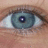 A close-up of a human eye with light blue-green iris and visible eyelashes, accompanied by pixelated red text reading 'im', 'watching', and 'you!!!' on white background.