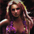 A pixelated static image shows a woman with long blonde hair wearing a purple bikini top against a dark background.