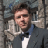 Static 48x48 pixel buddy icon showing a person in formal attire against a blurred background with visible dithering and low-resolution rendering artifacts.