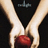 Two hands hold a red apple against a black background with faint blue text above.