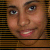 pixelated faces with brown skin and blue eyes, each face smiling with visible teeth, set against a dark striped background