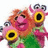 Pixelated cartoon character with orange hair and green clothing, multiple yellow-ringed eyes, pink text reading "Manah" and "boom" on black background.