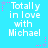Pixelated text "Totally in love with Michael" on cyan background with pink and purple star accents.