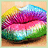 Pixelated close-up of lips with rainbow gradient colors, set against a soft peach background.