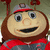Pixelated cartoon character with brown hair and red cap, smiling, wearing red and gray clothing, next to red background with text.