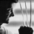 Black-and-white pixelated image of a person's profile with dark hair, wearing a light-colored shirt, against a gradient background with vertical lines.