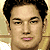 Pixelated portrait of a person with dark hair against light background, next to red graphic with white text 'THE NEW KILLER BEE 896.3' in blocky font.
