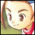 Pixelated close-up of a character's face with light skin, brown eyebrows, and large dark eyes, wearing a red garment against a green background.