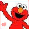 Red cartoon character with large eyes and orange nose waves left hand, smiling with open mouth, pink heart in lower left corner.