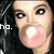 Pixelated close-up of a person with dark hair, pink lips, and visible eyes; partial white text 'ho.' on left side.