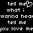 Pixelated text repeats 'tell me what i wanna hear' with a heart symbol replacing the 'o' in 'me', displayed on black background.