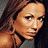 Pixelated image of a woman with long brown hair in a gray halter top, showing partial body views with visible text 'Coolbuddy.com' on a black background.