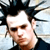 Pixelated close-up of a person with spiked black hair, light skin, and a dark shirt against a light blue background.