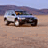 A pixelated image showing a vehicle in motion on a sandy terrain with blue text reading "BEAST WAGON" on the right side.