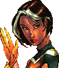 Pixelated character with dark hair and white streaks, wearing a green outfit with silver shoulder accents, holding up two hands emitting orange-yellow flames against gray background.