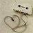 A static pixelated image shows a stylized heart shape with a small dark spot inside, set against a light beige background with faint horizontal lines.