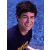 Pixelated image with pink text and hearts surrounding a photo of a person in dark clothing against blue background.