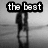 Black-and-white pixelated image of two figures embracing on a beach, with text overlays forming a phrase across four