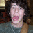 A pixelated image shows a person with curly dark hair and open mouth on the left, next to a black text box with pink lettering reading "Nick J is off the chain" on white background.