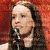 six with red borders: top-left shows a woman singing into a microphone against a red background; the other five contain black backgrounds with white text fragments