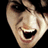 A pixelated close-up of a person's face with an open mouth and wide eyes, next to red text reading BOO! on black background.