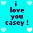 Pixelated cyan background with repeated dark purple text 'i love you casey!' and white/light blue heart symbols arranged in a pattern